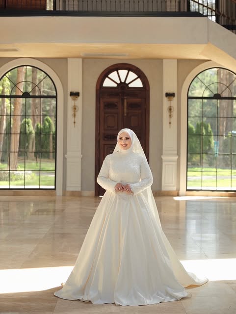 Süveyla Balasor Bridal imzalı kapalı yaka, prenses siluet tesettür gelinlik ön cepheden görünüm
